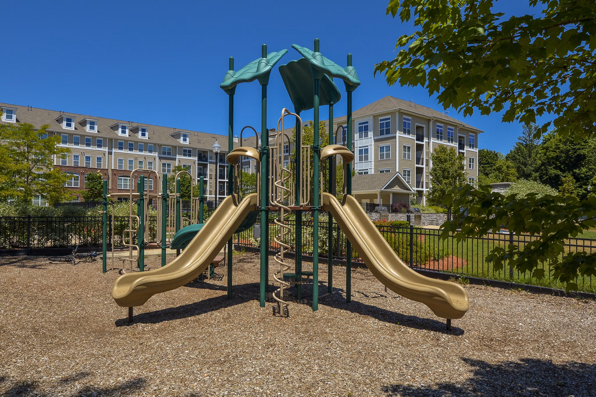 Marquee at Andover: Modern playground with swings and slides for family-friendly living at luxury apartments