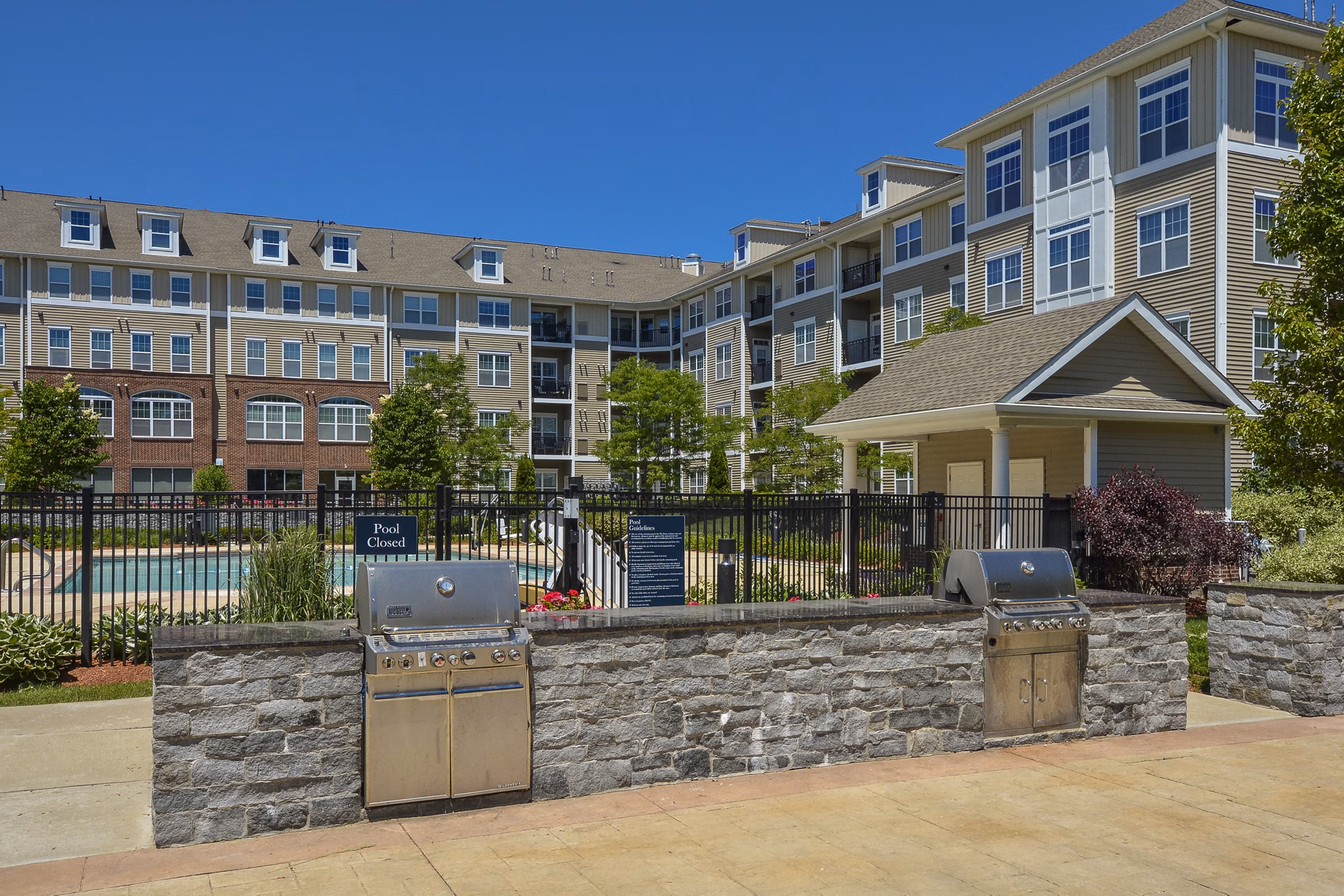 Outdoor grill area with modern seating at Marquee at Andover Apartments
