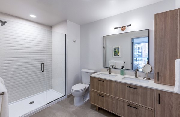 Modern bathroom with sleek fixtures and stylish tiles at Illume Apartments