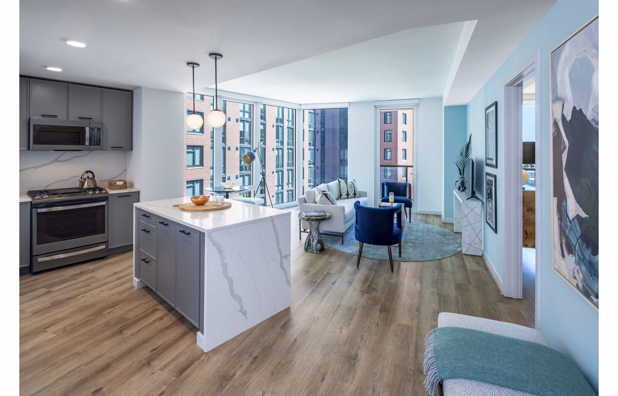 Modern kitchen with stainless steel appliances in Illume Apartments, featuring sleek countertops and designer cabinetry