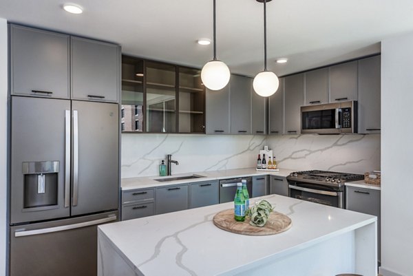 Modern kitchen with stainless steel appliances at Illume Apartments