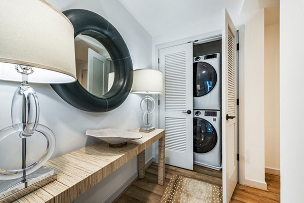 Laundry room featuring modern appliances at Illume Apartments, offered by Greystar luxury apartments