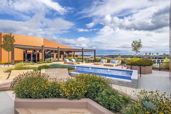 Cozy patio with outdoor seating at Illume Apartments, perfect for relaxation and enjoying scenic views