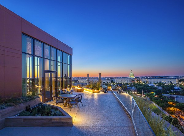 Charming patio with outdoor seating at Illume Apartments, perfect for relaxing and enjoying views