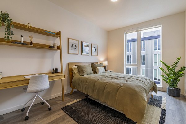 Modern bedroom with natural lighting at Verde Esterra Park Apartments, offering stylish comfort in a sustainable living environment
