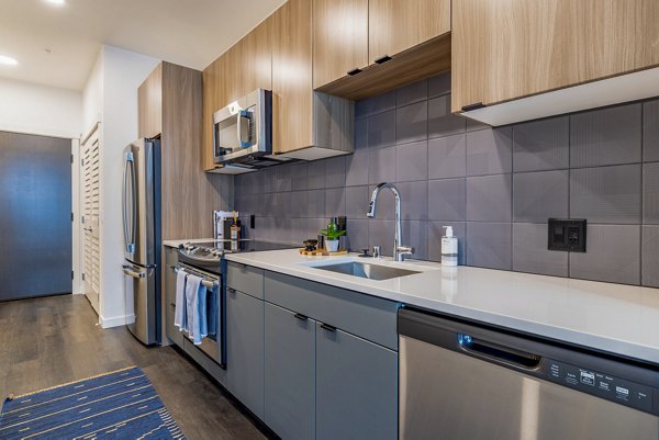 Sleek kitchen featuring stainless steel appliances at Verde Esterra Park Apartments