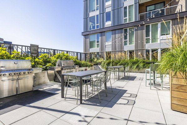 Outdoor grill area with modern seating at Verde Esterra Park Apartments
