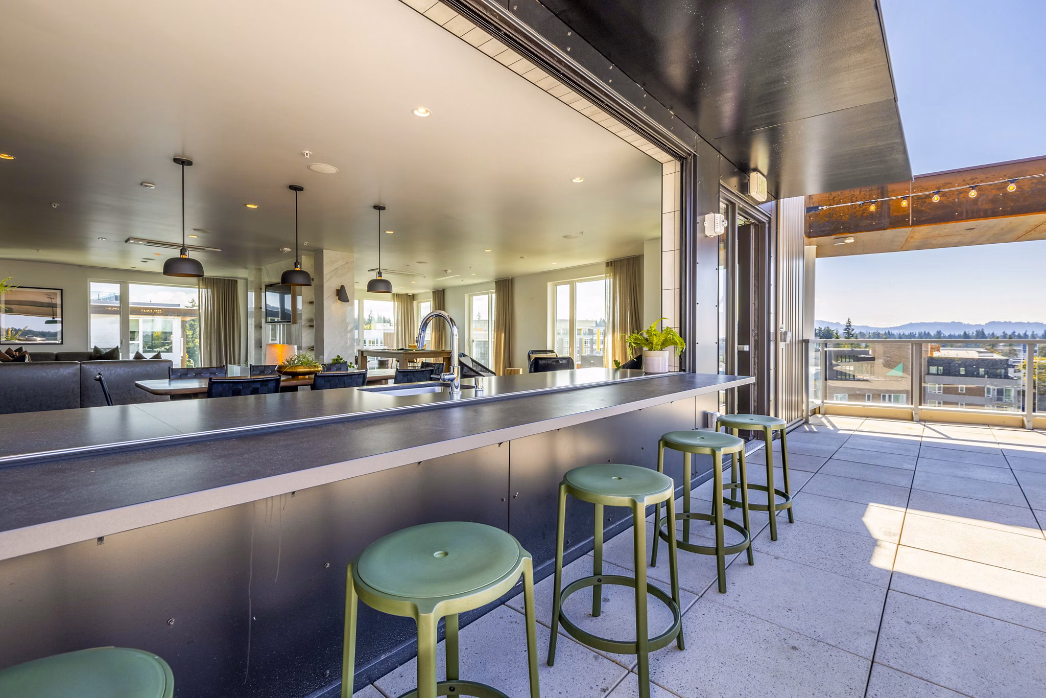 Stylish clubhouse patio with modern seating at Verde Esterra Park Apartments in Redmond, Washington