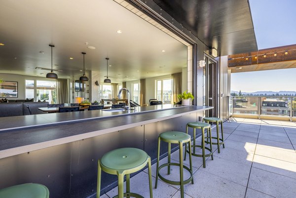 Stylish clubhouse patio with modern seating at Verde Esterra Park Apartments in Redmond, Washington