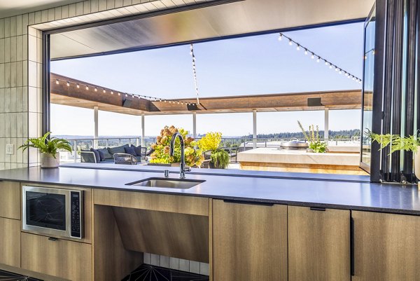 Spacious clubhouse patio with comfortable seating at Verde Esterra Park Apartments in Redmond, ideal for social gatherings