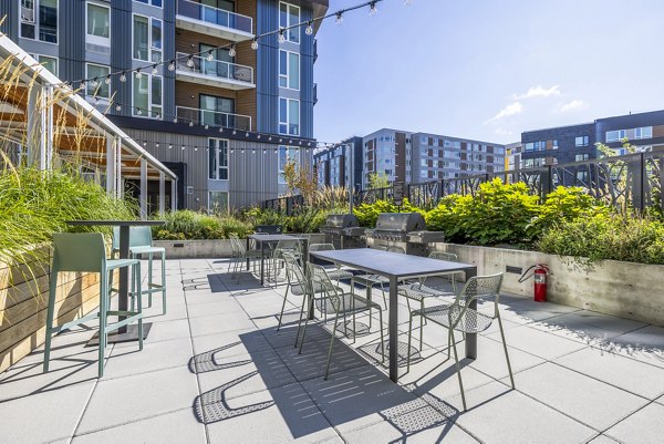 Grill area on patio at Verde Esterra Park Apartments featuring outdoor seating and modern design
