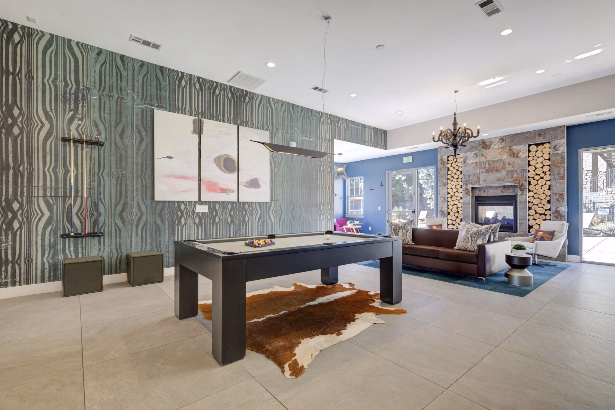 Game room with billiards table and lounge seating at Prosper Place Apartments
