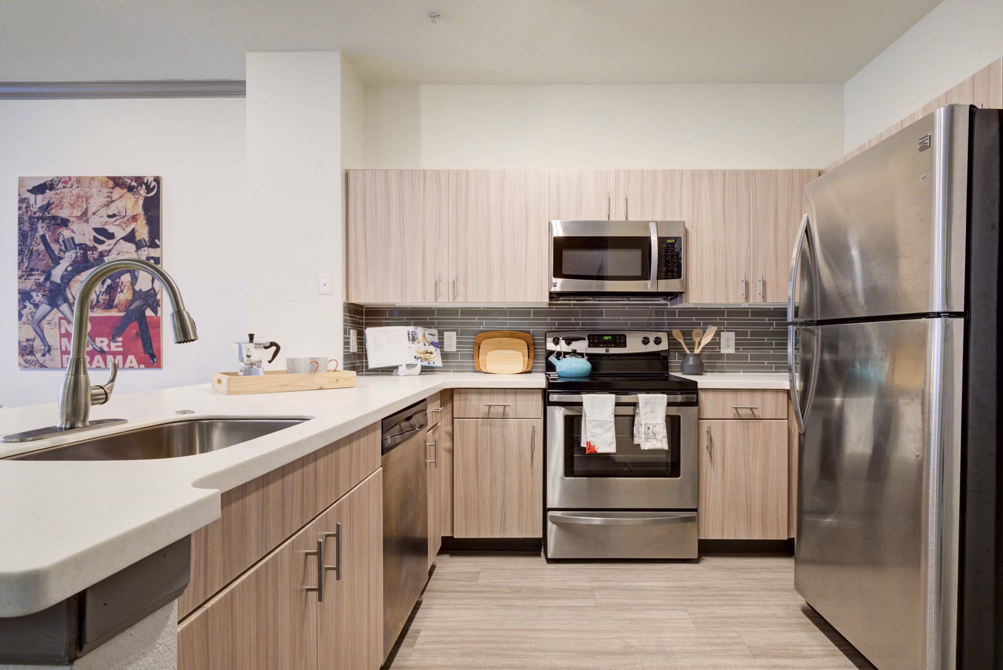 Modern kitchen with stainless steel appliances at Prosper Place Apartments