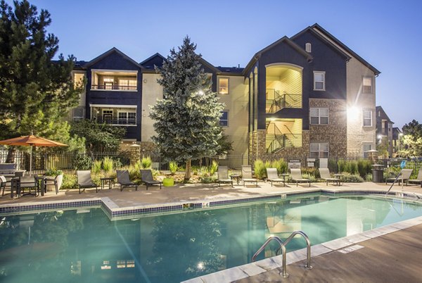 Resort-style pool with lounge seating at Prosper Place Apartments, offering a luxury lifestyle in a vibrant community setting