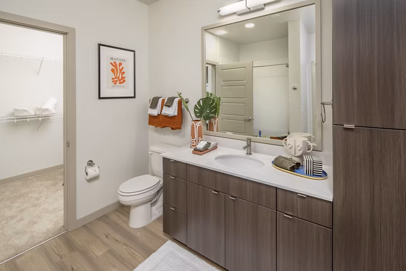 Modern bathroom with sleek fixtures at The Dylan Apartments, a luxury Greystar property, featuring elegant tile design and spacious vanity