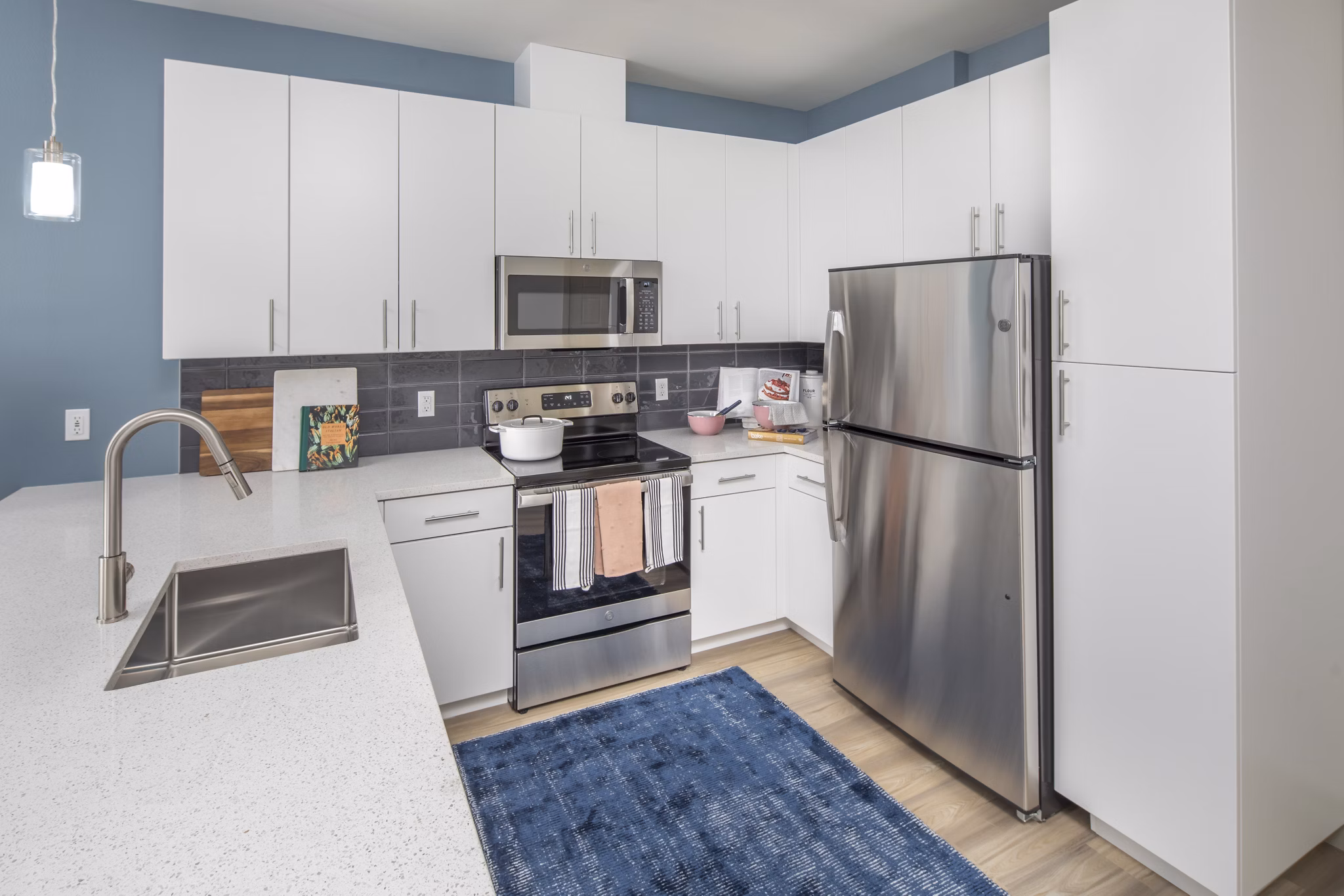 Modern kitchen featuring stainless steel appliances and granite countertops at The Dylan Apartments