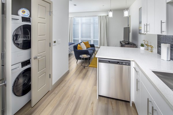 Contemporary kitchen with stainless steel appliances at The Dylan Apartments