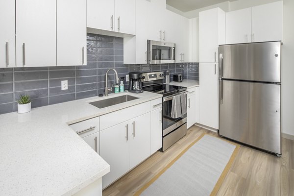 Modern kitchen with stainless steel appliances at The Dylan Apartments