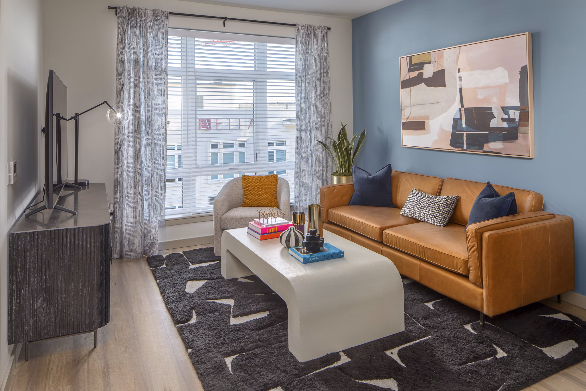 Spacious living room with modern decor and natural light at The Dylan Apartments