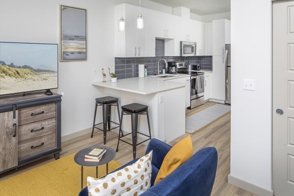 Cozy living room with modern decor at The Dylan Apartments, offering luxury living with spacious design and premium amenities in a prime location