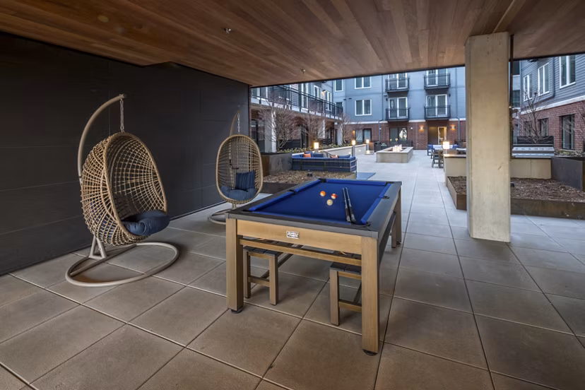 Basketball court with hoop and seating at The Dylan Apartments, ideal for residents' sport activities in a luxury setting