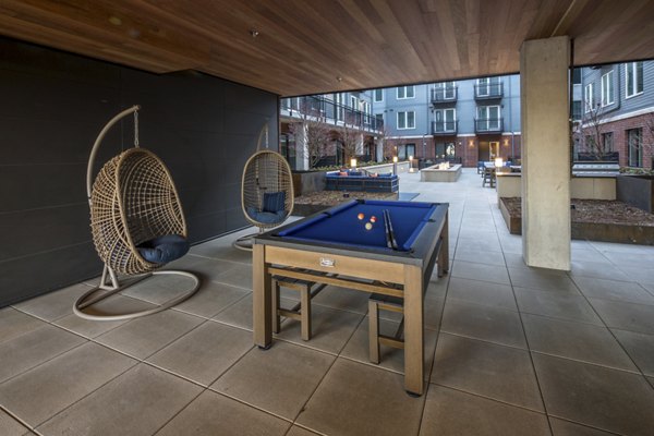 Basketball court with hoop and seating at The Dylan Apartments, ideal for residents' sport activities in a luxury setting