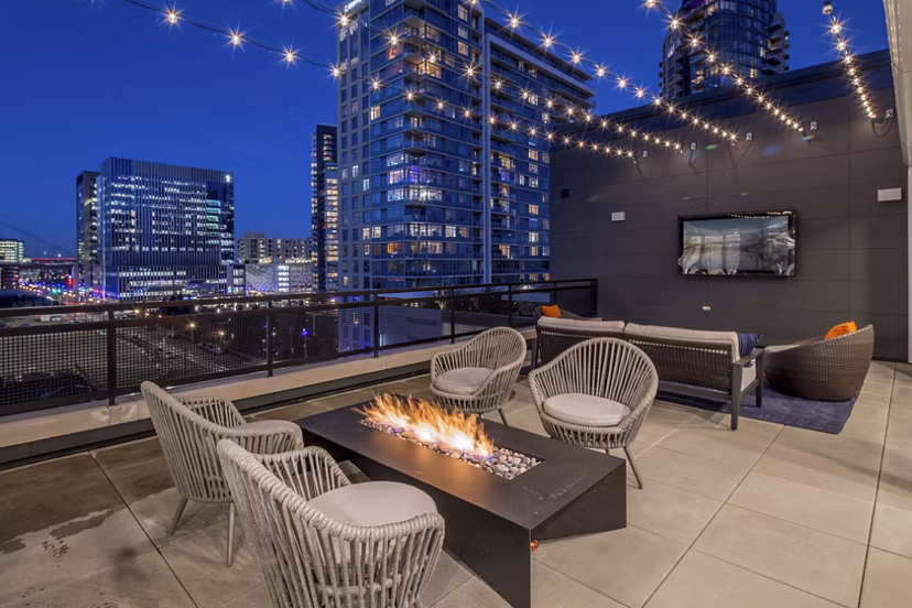 Outdoor fire pit lounge area at The Dylan Apartments, providing luxury relaxation with cozy seating in a stylish community setting
