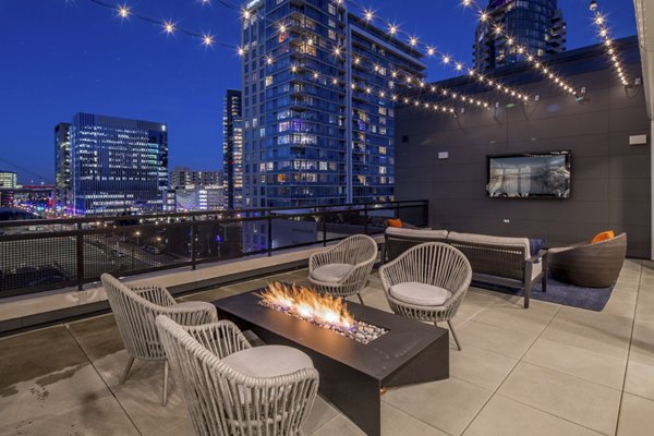 Outdoor fire pit lounge area at The Dylan Apartments, providing luxury relaxation with cozy seating in a stylish community setting