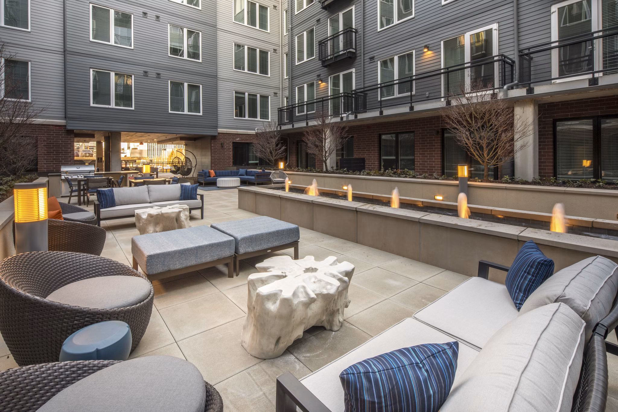 The Dylan Apartments: Serene courtyard featuring lush greenery and seating areas in this luxury property