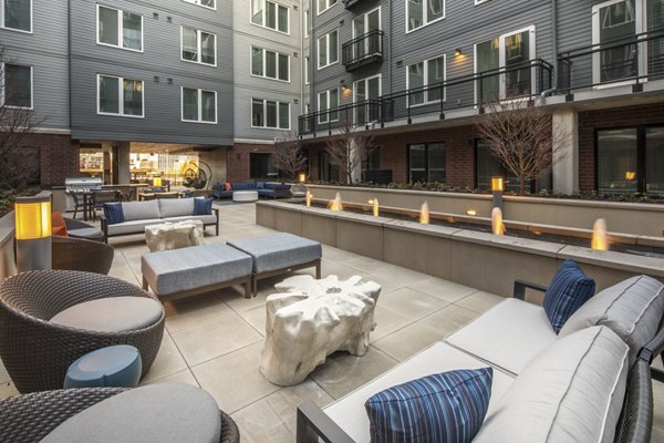 The Dylan Apartments: Serene courtyard featuring lush greenery and seating areas in this luxury property