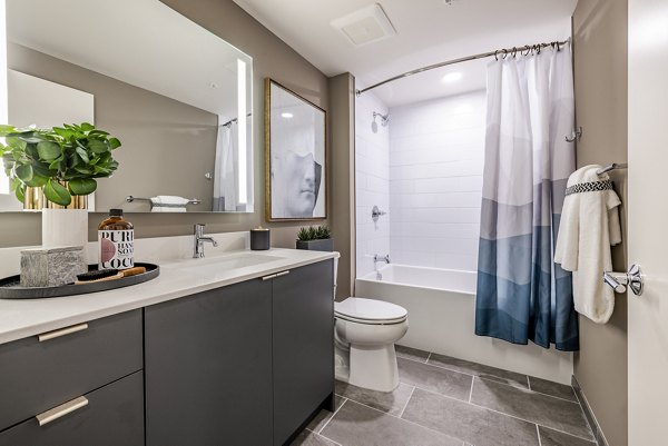 Luxurious bathroom with sleek fixtures and marble countertops at The Waverly Apartments
