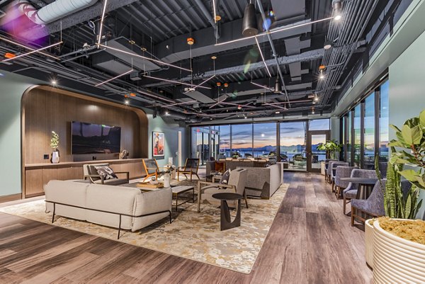 Modern clubhouse with open seating and lounge area at The Waverly Apartments in luxury Greystar community