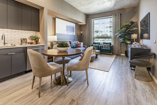 Dining area with modern furnishings at The Waverly Apartments, featuring elegant lighting and open layout