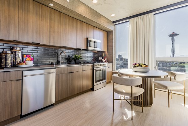 Dining area with modern decor featuring stylish lighting and seating at The Waverly Apartments, a Greystar luxury property