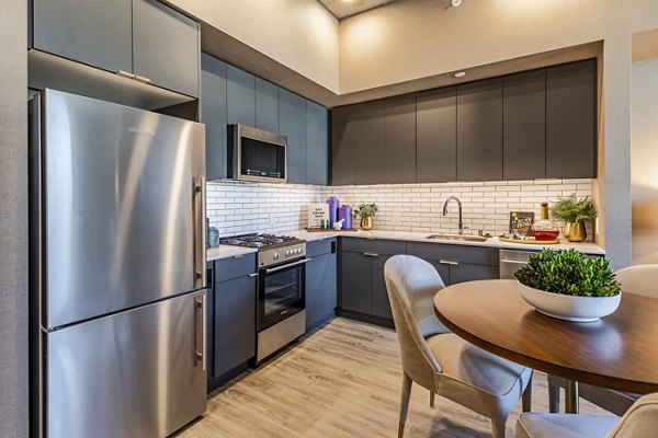 Modern kitchen with stainless steel appliances at The Waverly Apartments