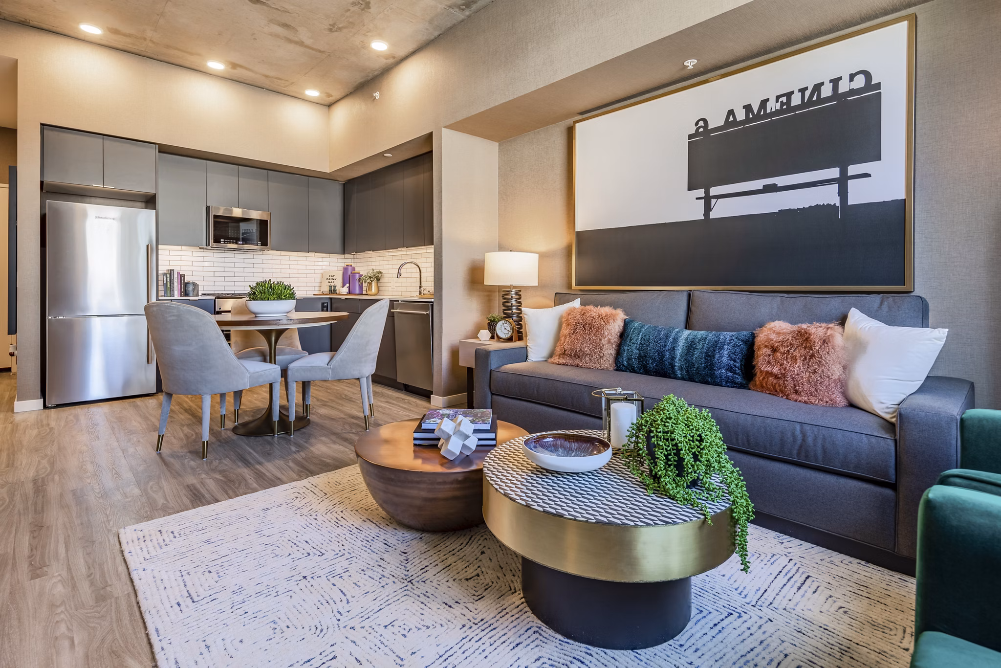 Modern living room with sleek furniture and large windows at The Waverly Apartments