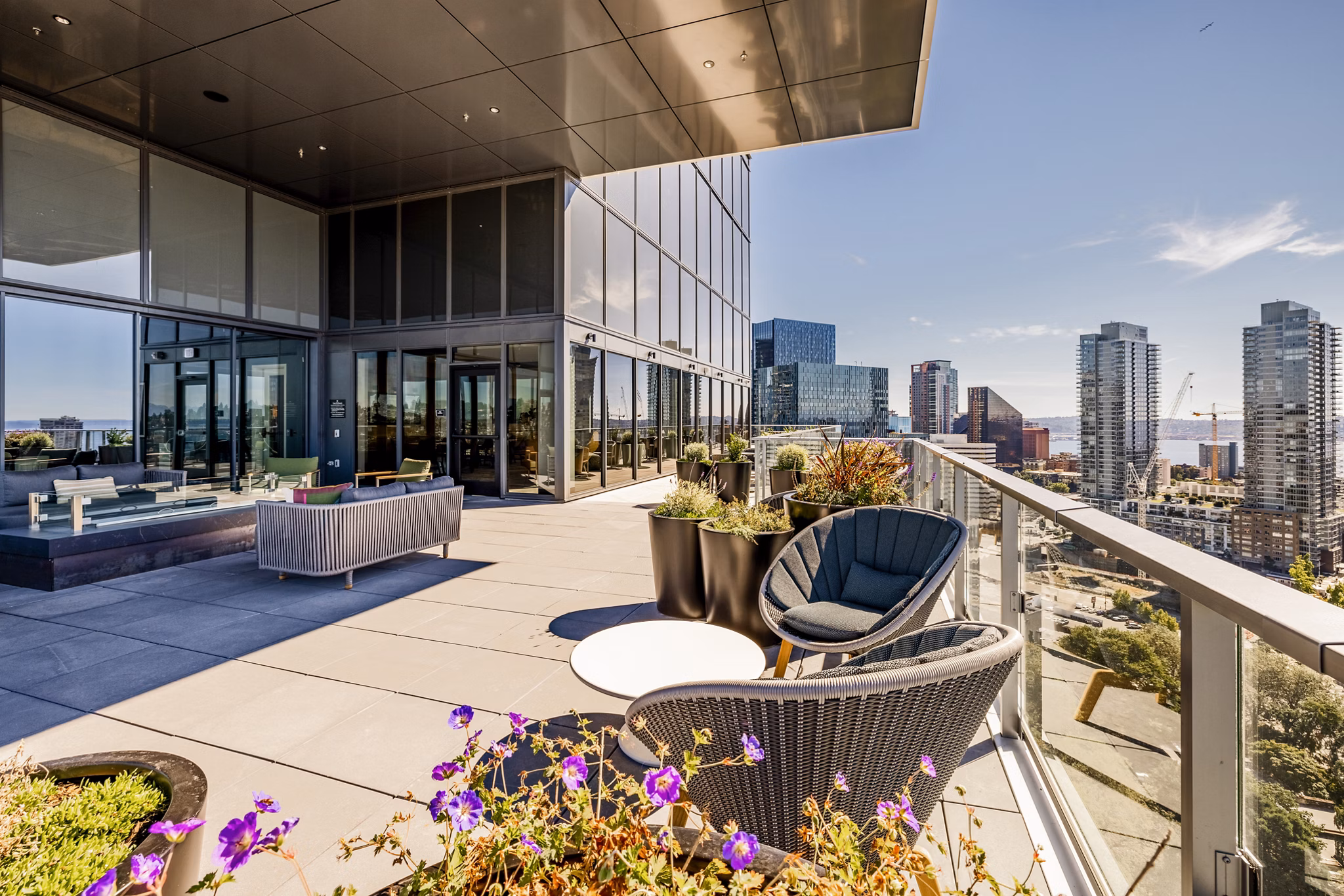 Patio with modern seating and green views at The Waverly Apartments