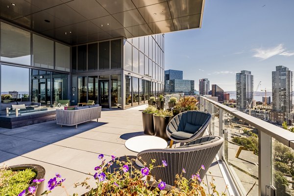 Patio with modern seating and green views at The Waverly Apartments