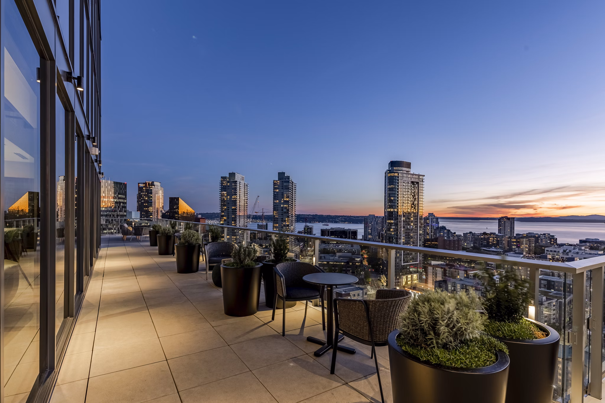 Patio with modern seating and lush greenery at The Waverly Apartments