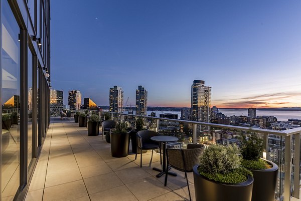 Patio with modern seating and lush greenery at The Waverly Apartments