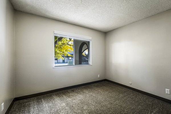Bedroom featuring modern decor and natural light at Calero Apartments