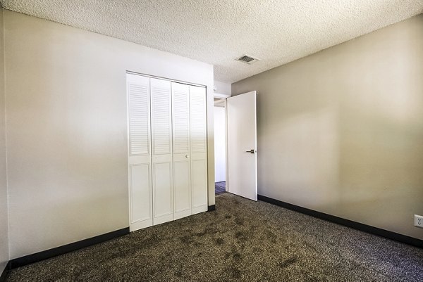 Cozy bedroom with modern decor at Calero Apartments, luxury living in a serene setting