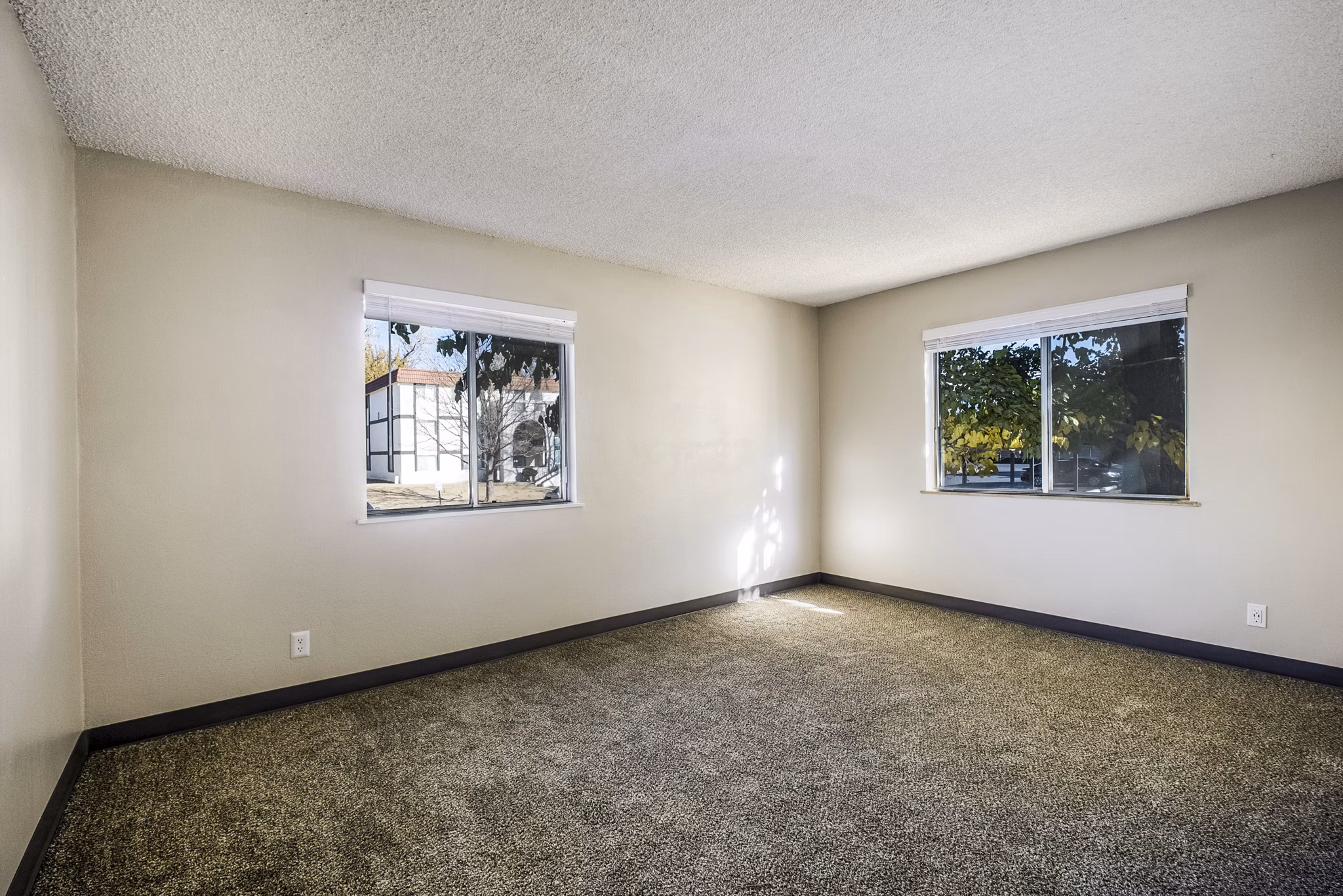 Modern bedroom featuring elegant furnishings and large windows at Calero Apartments, luxury living in a Greystar-managed community