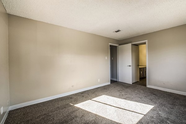 Cozy bedroom with modern decor at Calero Apartments, featuring luxurious finishes and ample natural light