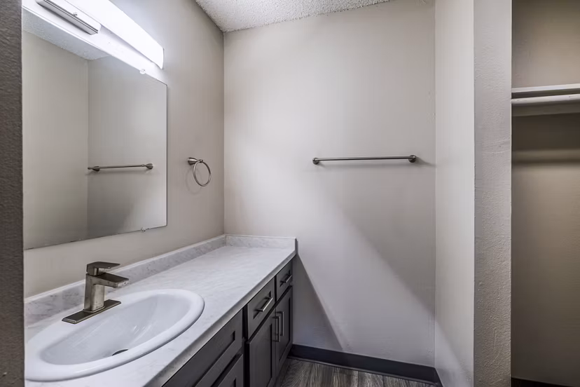 Luxurious bathroom with marble countertops and modern fixtures at Calero Apartments