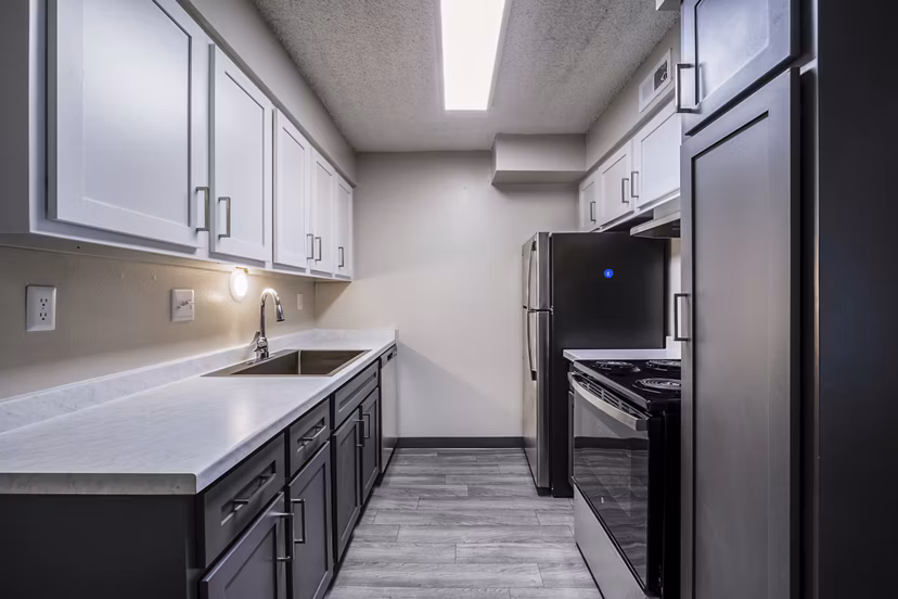 Modern kitchen featuring sleek cabinetry and stainless steel appliances at Calero Apartments