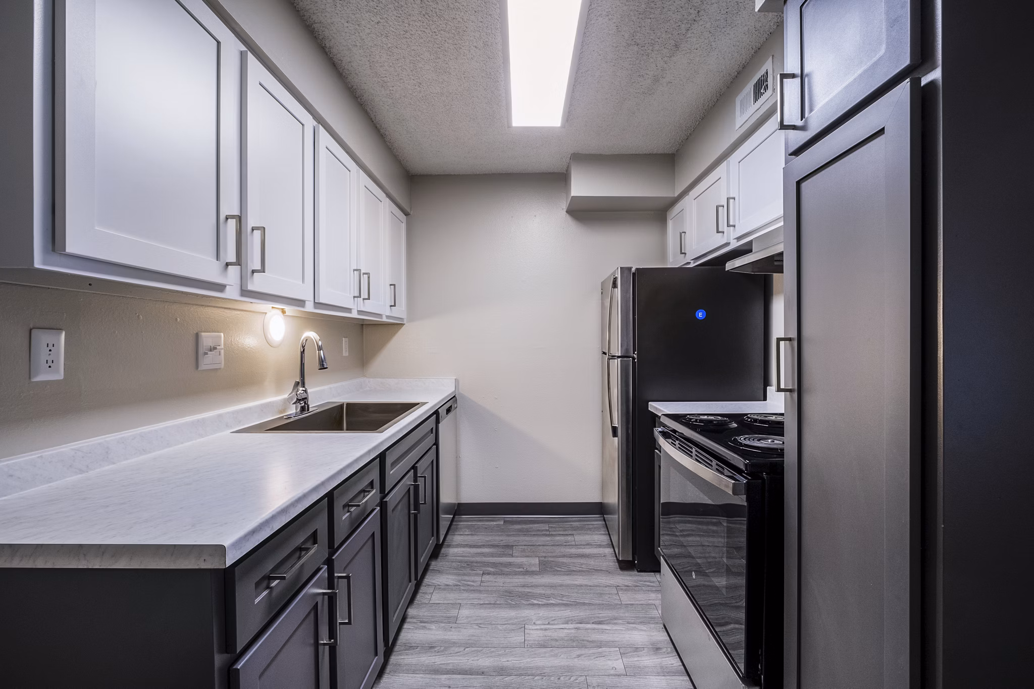 Modern kitchen featuring sleek cabinetry and stainless steel appliances at Calero Apartments