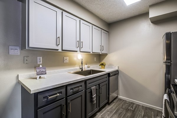 Modern kitchen with stainless steel appliances at Calero Apartments