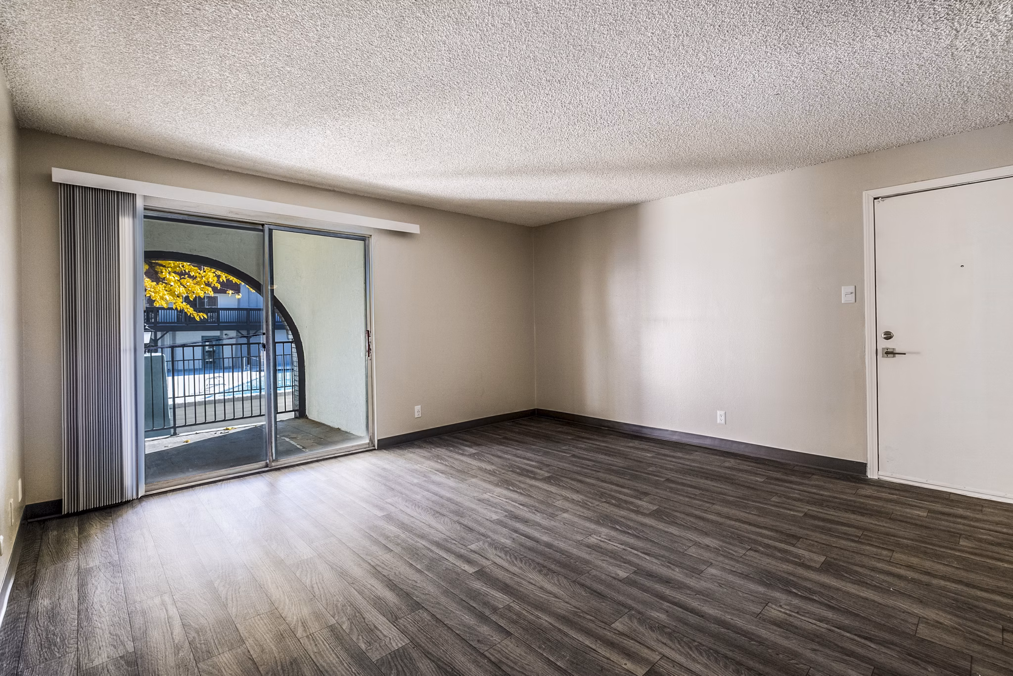 Living room with modern decor and large windows in Calero Apartments