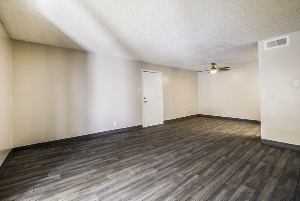 Spacious living room with modern decor at Calero Apartments, featuring luxury design elements and ample natural light